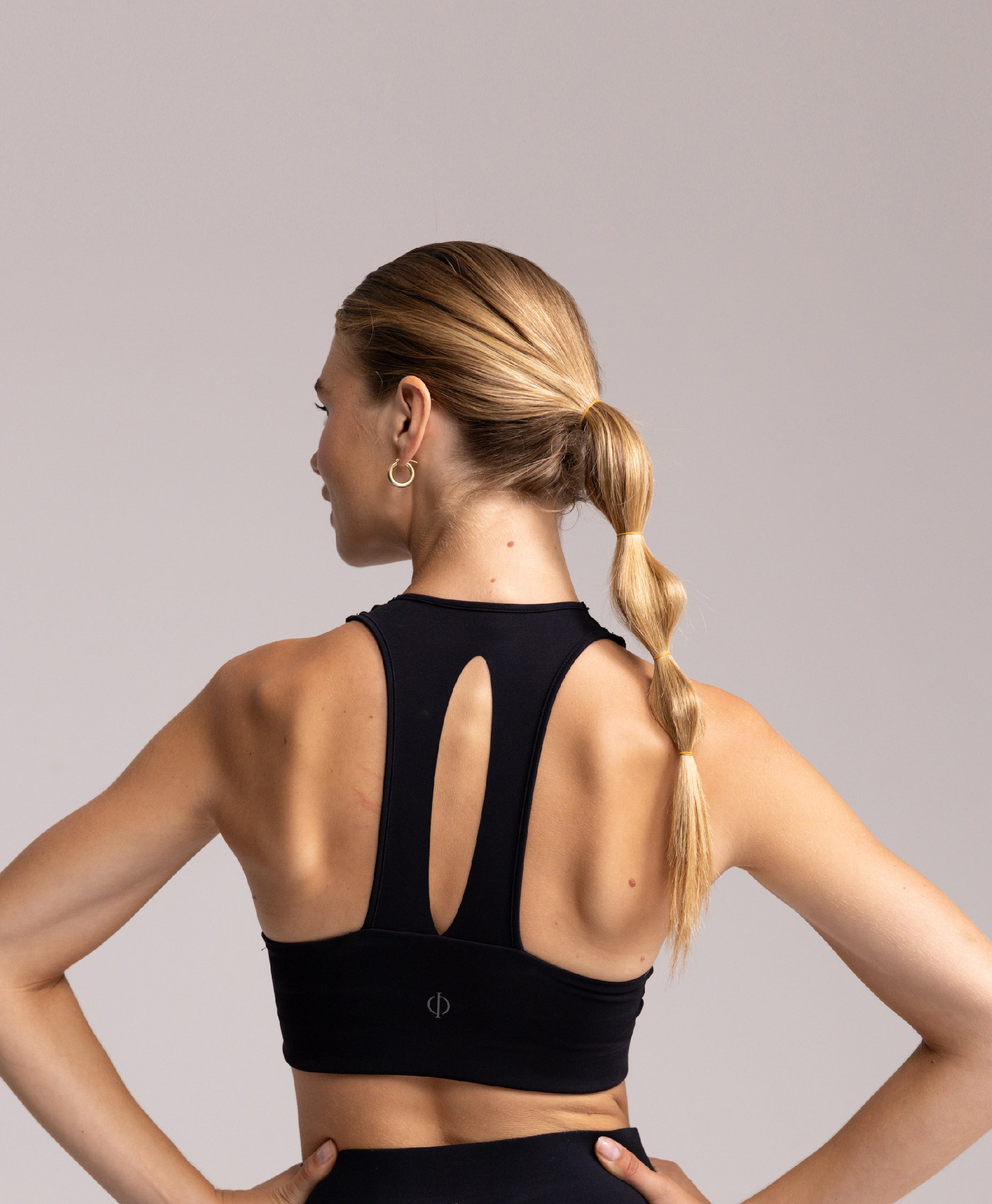 Back view of the Philos Armor Bra, highlighting the T-back design that allows for unrestricted arm movement during runs.