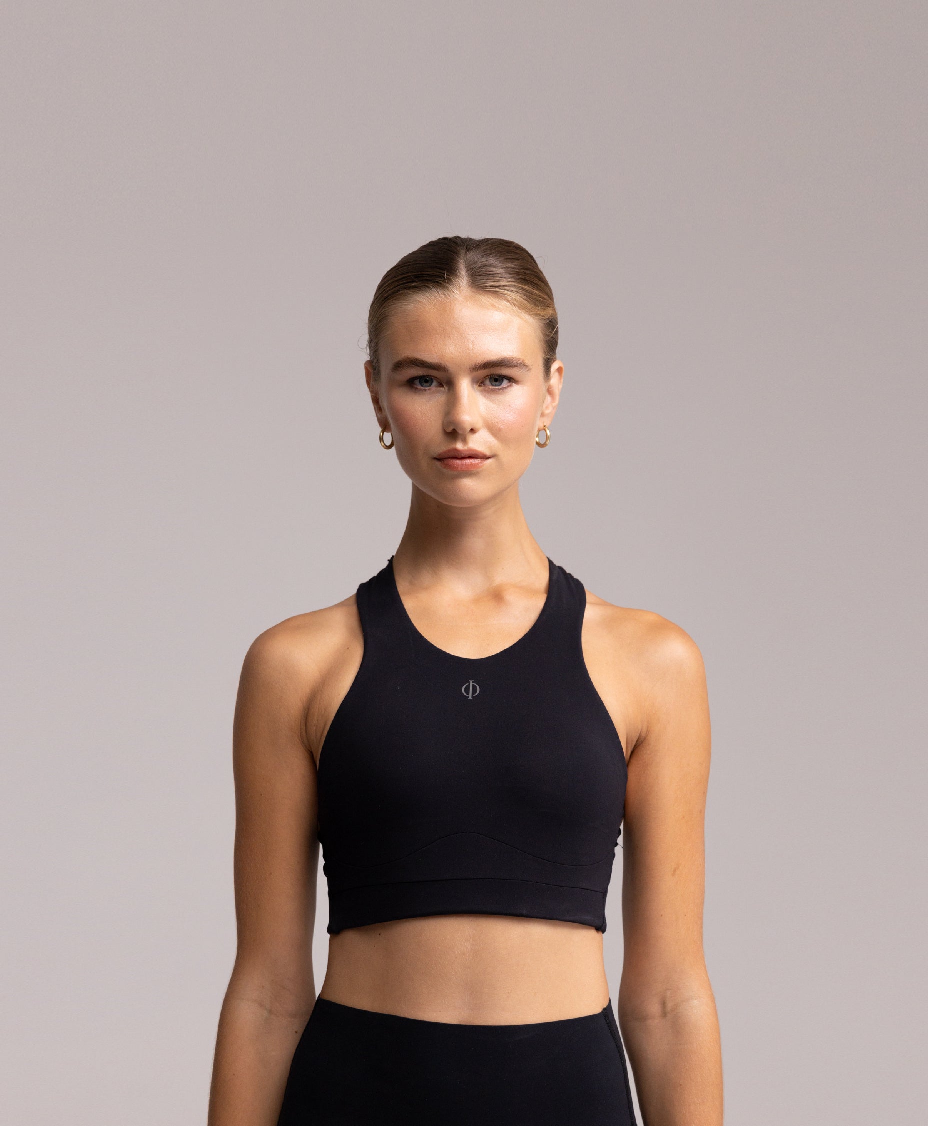 Front view of the Philos Armor Running Bra, showcasing the racerback design and form-fitting silhouette for optimal support.