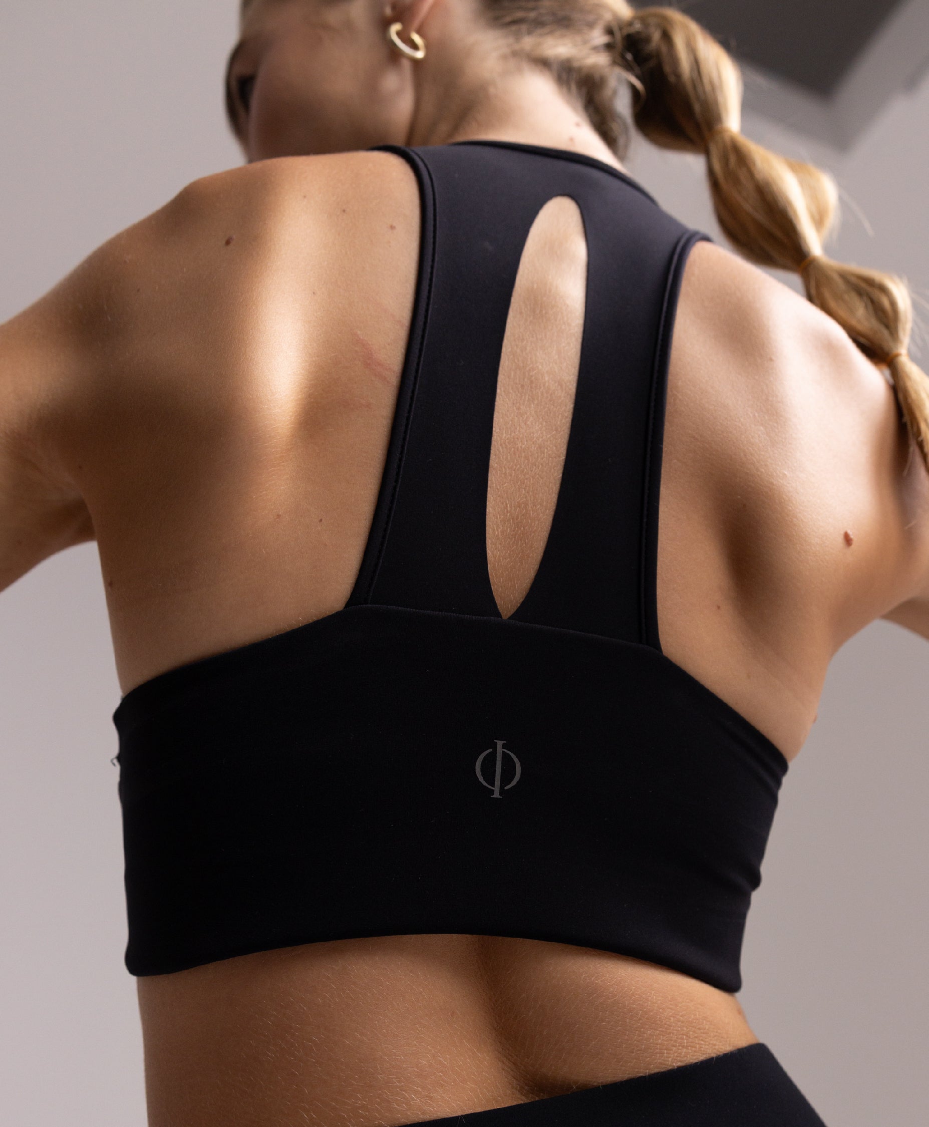 Back view of the Philos Armor Bra, highlighting the T-back design that allows for unrestricted arm movement during runs.