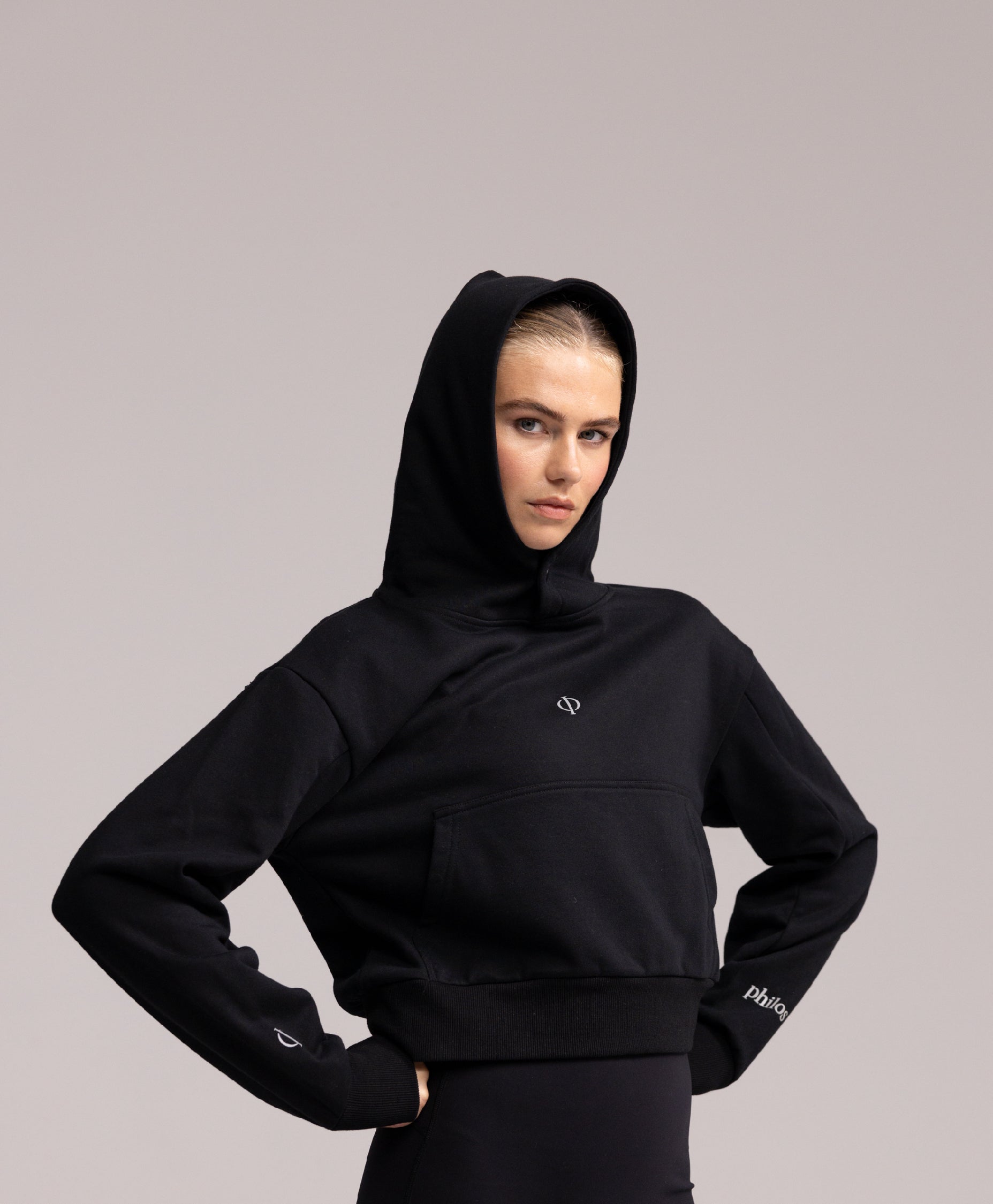 Close-up of the Philos Armor Running Hoodie, featuring the soft, breathable 100% cotton fabric and reflective logos.