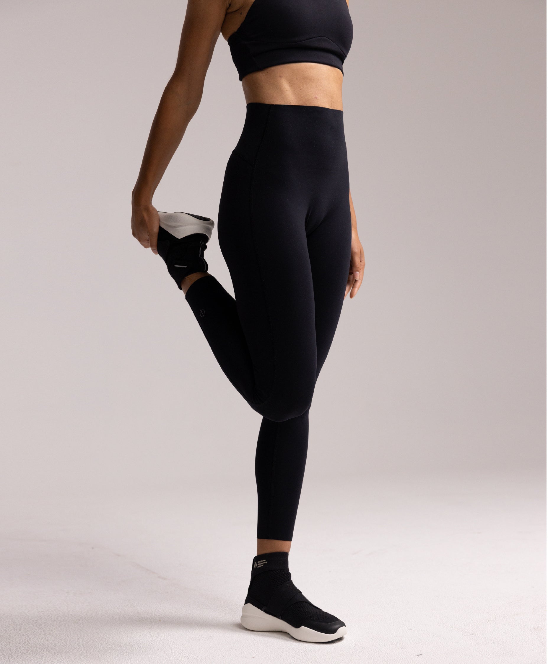 Side view of the Philos Armor Running Tights, showing the breathable 4-way stretch fabric and laser-cut hems, designed for a sleek, comfortable fit.